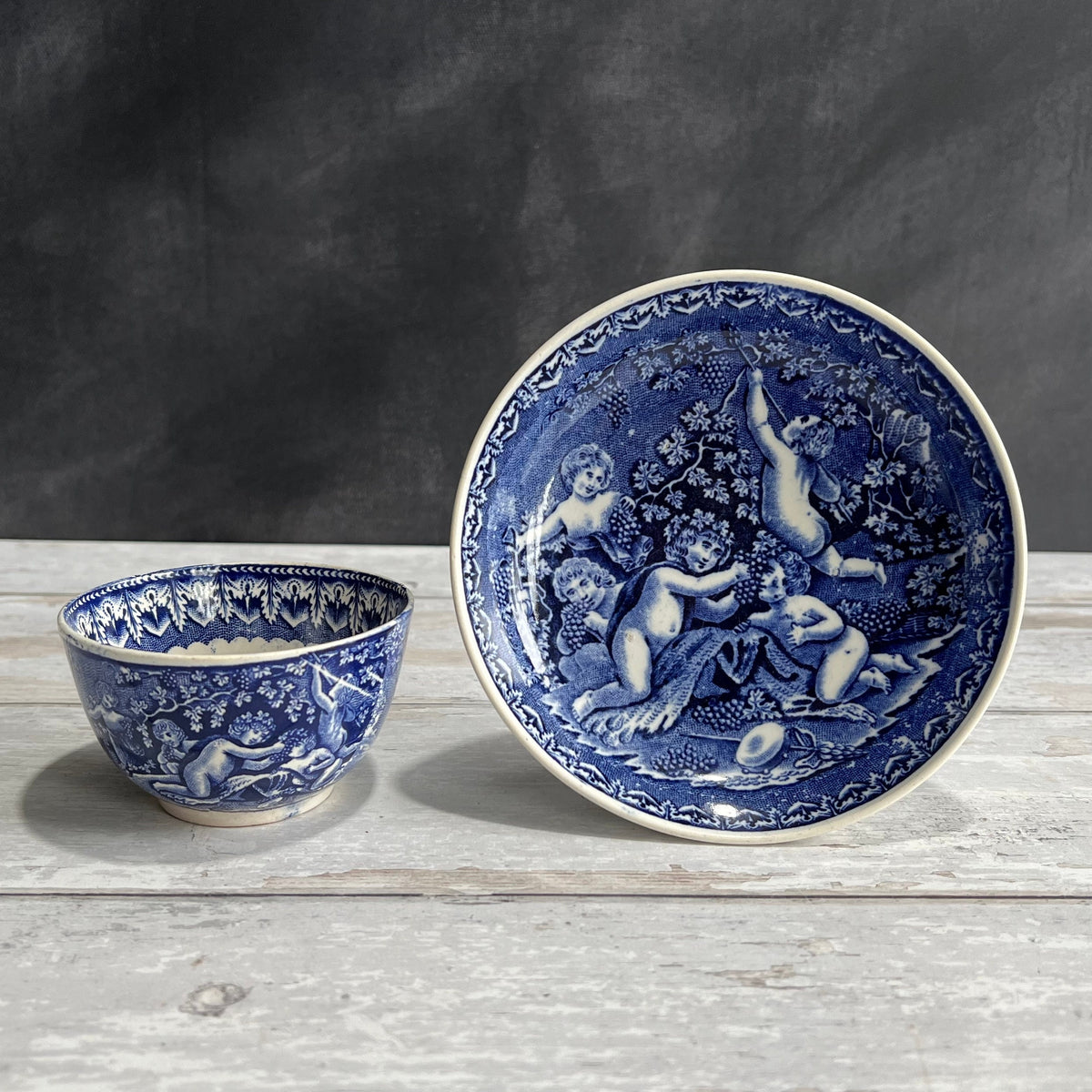 19th Century Transferware Tea Bowl And Saucer Bacchanalian Cherubs Scene Blue And White C 1815